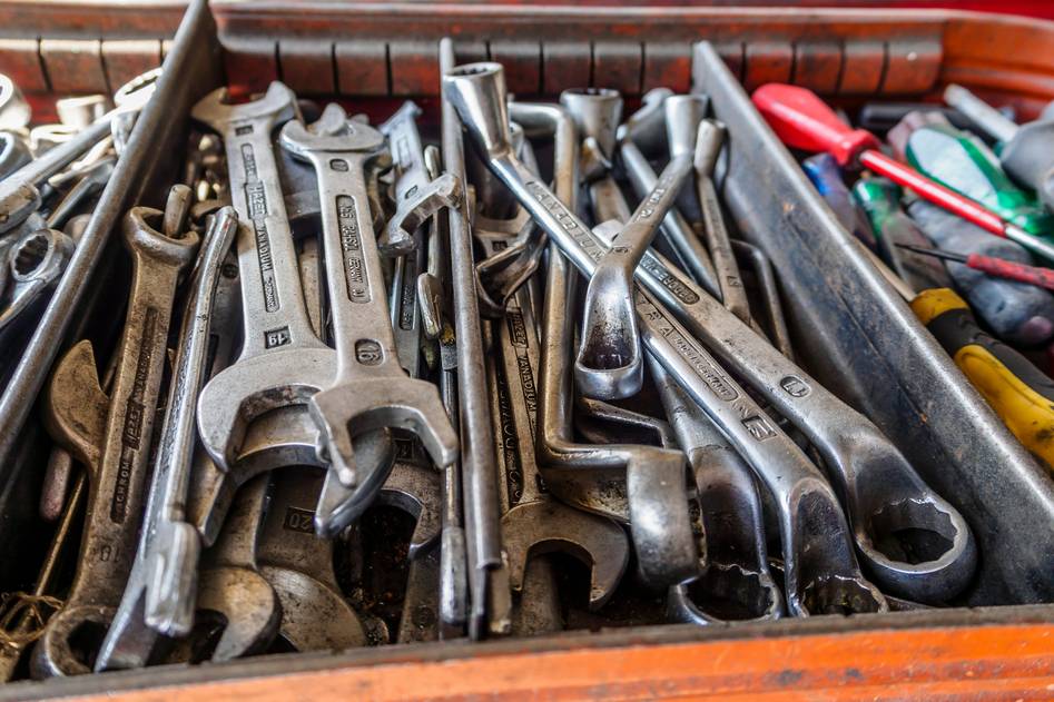 Open rolling tool chest showing organized hand tools and hardware